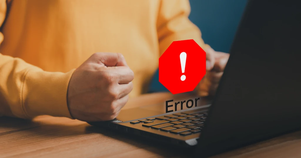man with fist on laptop and an error logo hovering above the laptop