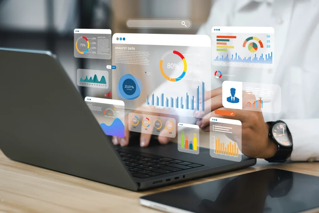 a man using his laptop with different graphs and data hovering above the laptop